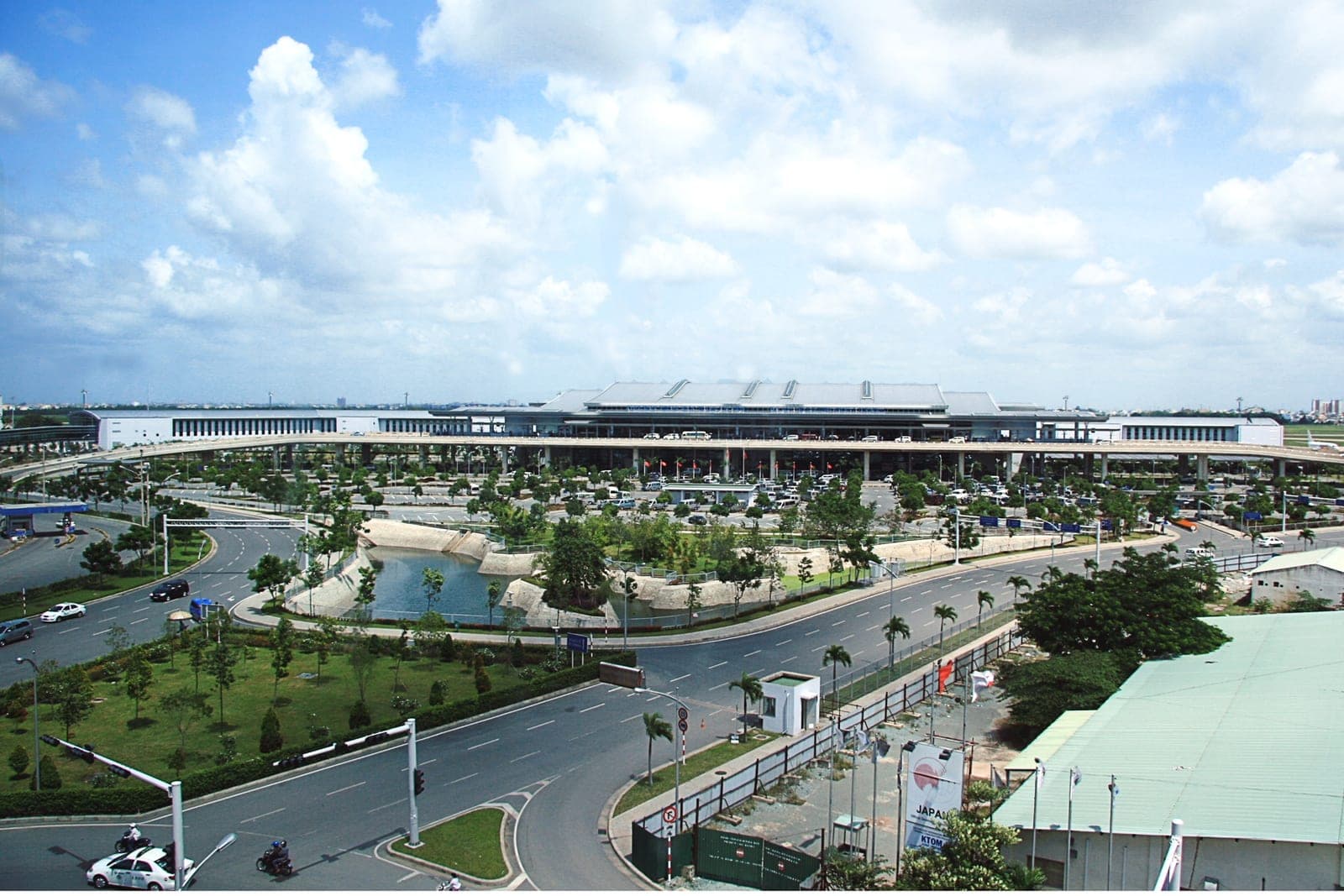 Wide view of Tan Son Nhat International Airport in Ho Chi Minh City, Vietnam, with aircraft parked and airport infrastructure under clear skies.