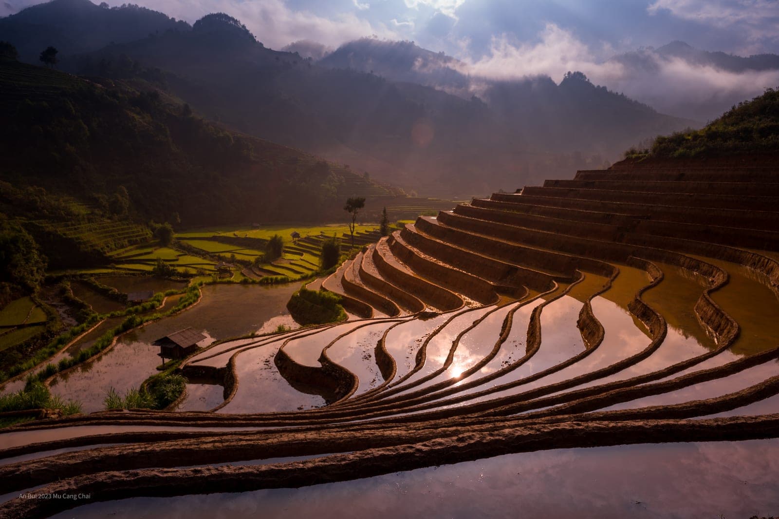 Cascading rice terraces in Vietnam with water reflection, showing the agricultural landscape and seasonal farming in the highlands.