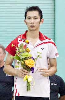 Nguyen Tien Minh executing a shot during the US Open Badminton 2011 tournament, showcasing his athletic form and racket technique.