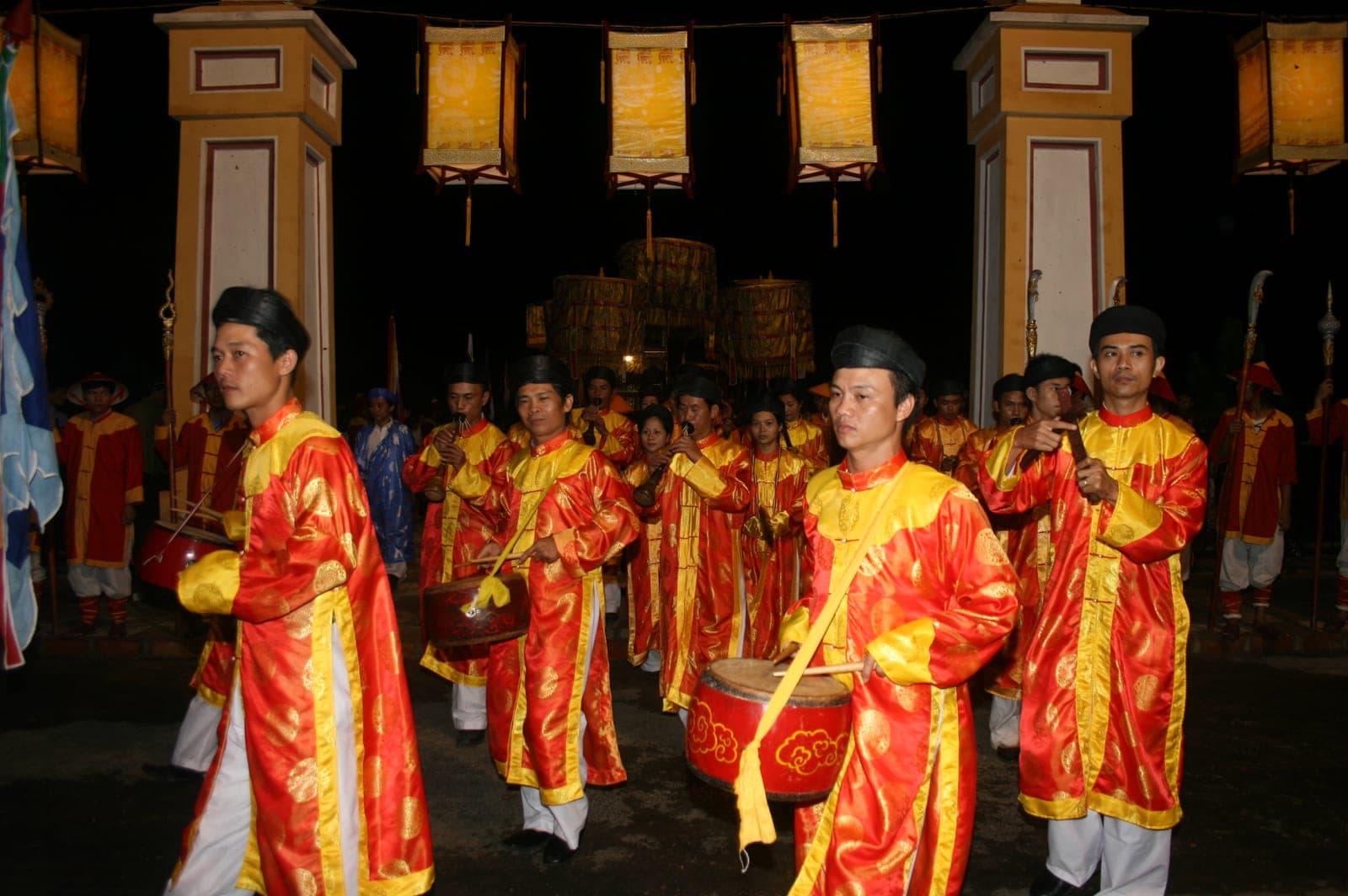 Traditional court musicians dressed in formal period costumes playing classical instruments during an imperial court music ensemble performance.