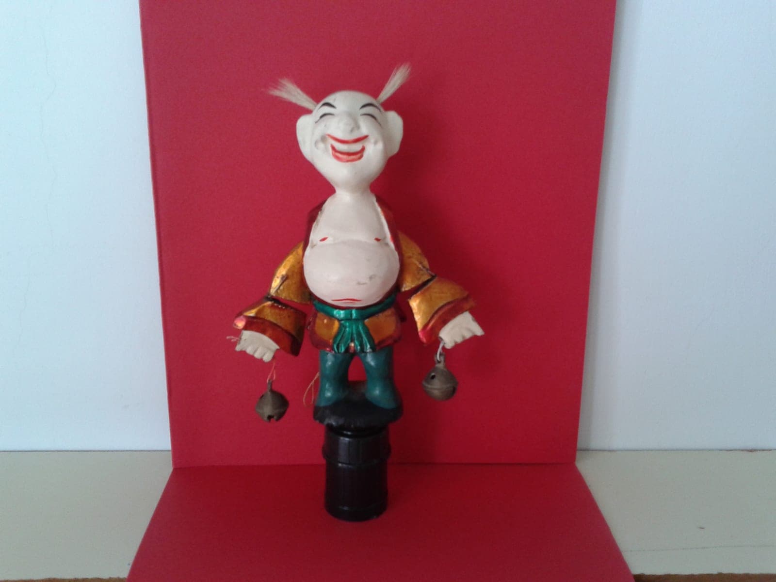 Traditional Vietnamese wooden water puppet with articulated arms, approximately 15cm tall, colorfully painted for traditional Hanoi water puppet theatre.