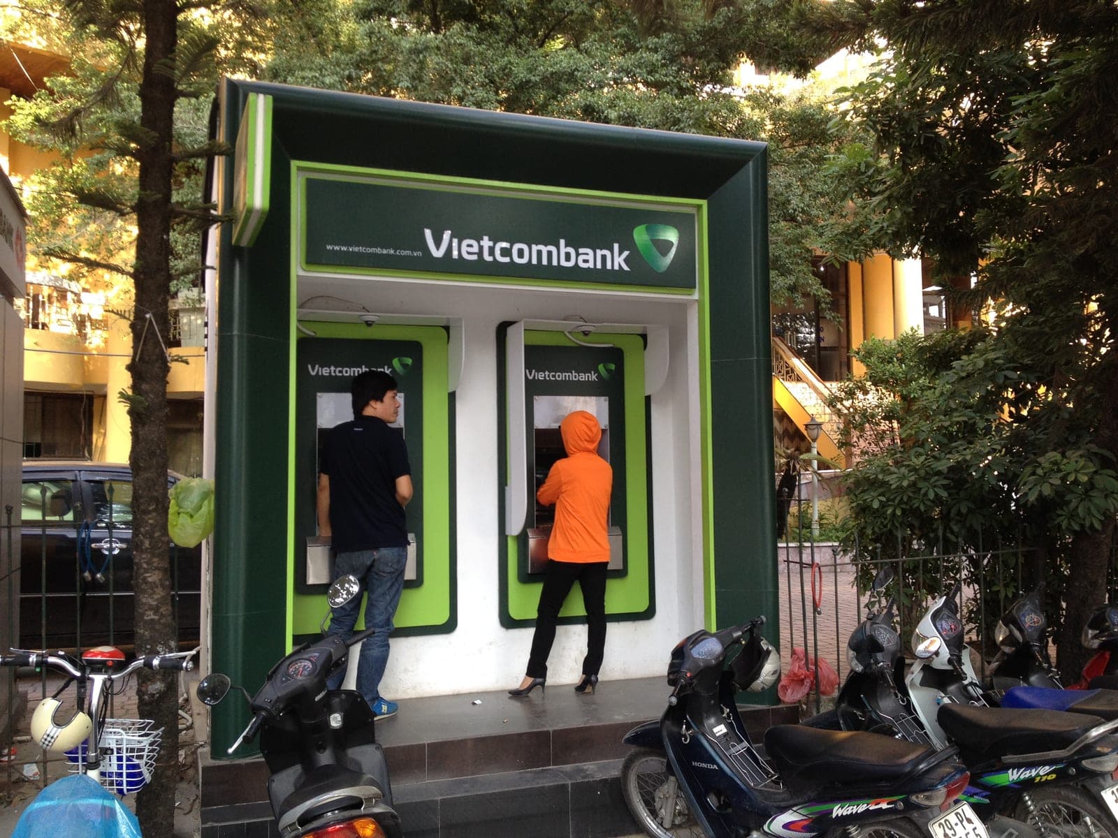 Vietcombank ATM kiosk mounted on a street corner in Hanoi's Văn Cao district