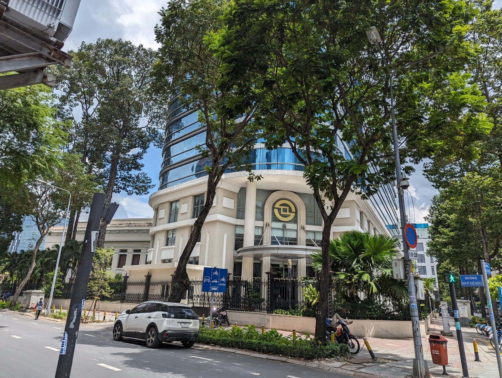 Urban downtown skyline with modern office buildings and busy street in District 1, Ho Chi Minh City.