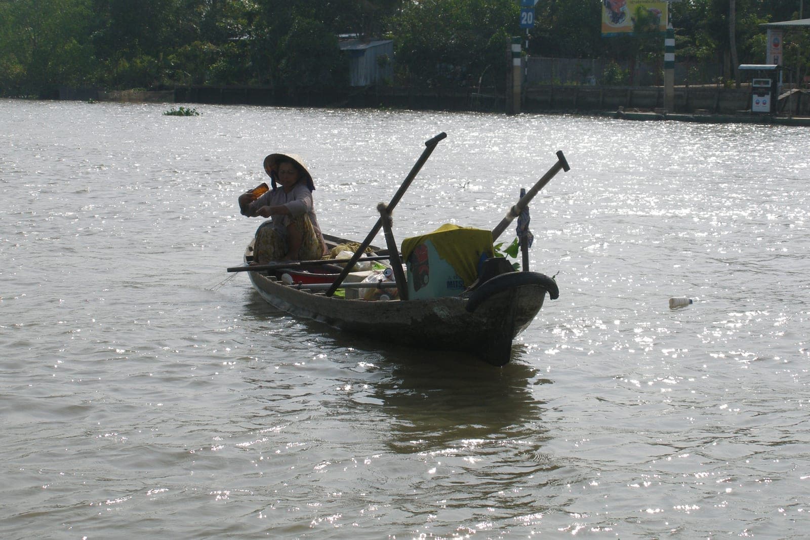 Waterway in Phong Dien with boats and mangrove vegetation along the Mekong Delta river landscape